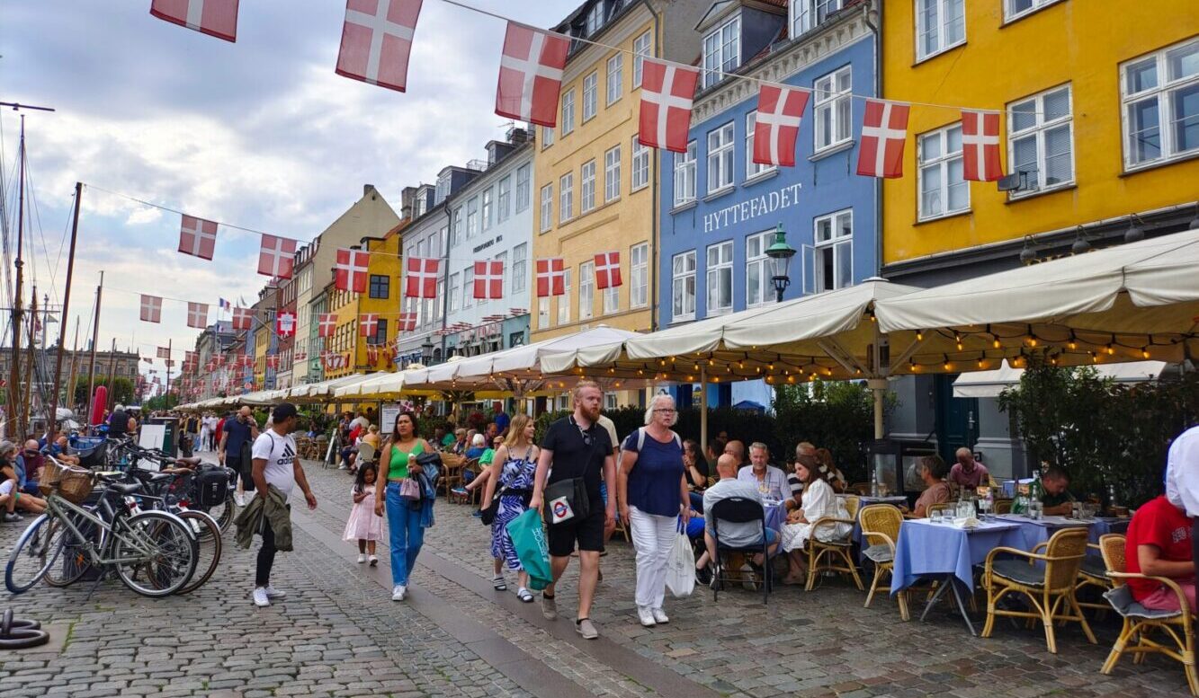 Denmark Copenhagen people crossing a bridge Joshi Milestoner Denmark Copenhagen people outside Joshi Milestoner