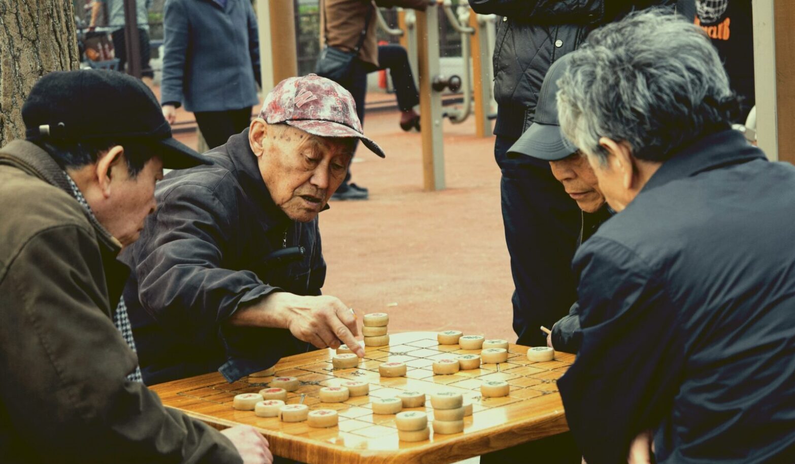 Seniors playing Chinese chess on the street in Beijing. Photo by Woody Yan Seniors playing Chinese chess on the street in Beijing. Photo by Woody Yan